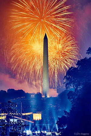 Orange Fireworks and a Hazy Monument