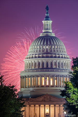 The Capitol dome with pink and purple fireworks